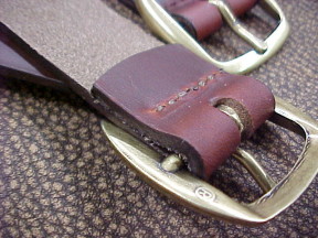 trunk straps with stitched leather and brass buckles